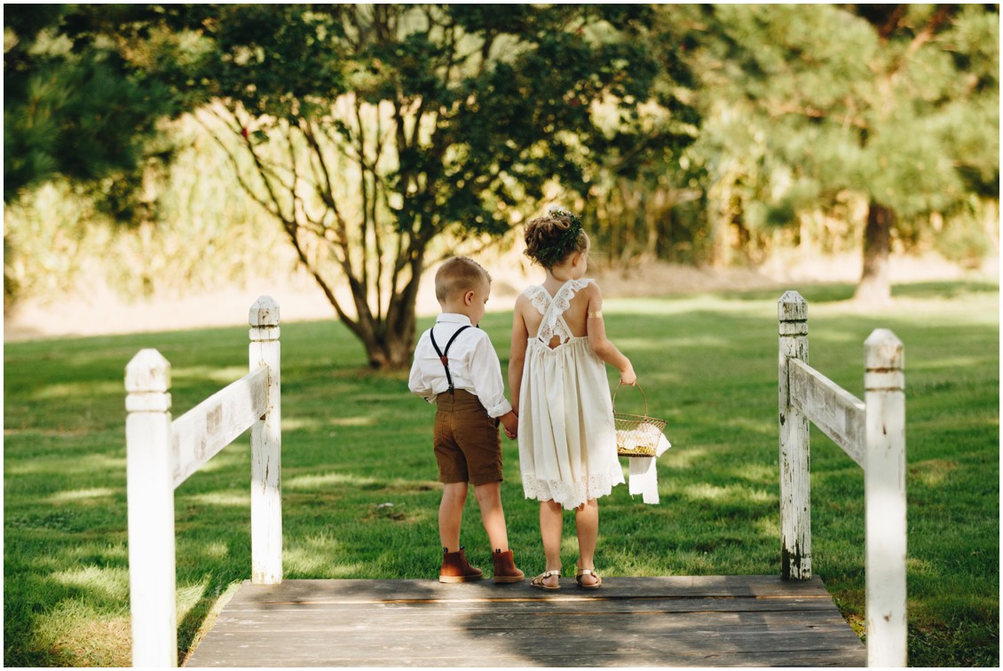 Flower girl in white flowy dress and ring bearer in a button up shirt and shorts. |Eastern Shore Wedding|