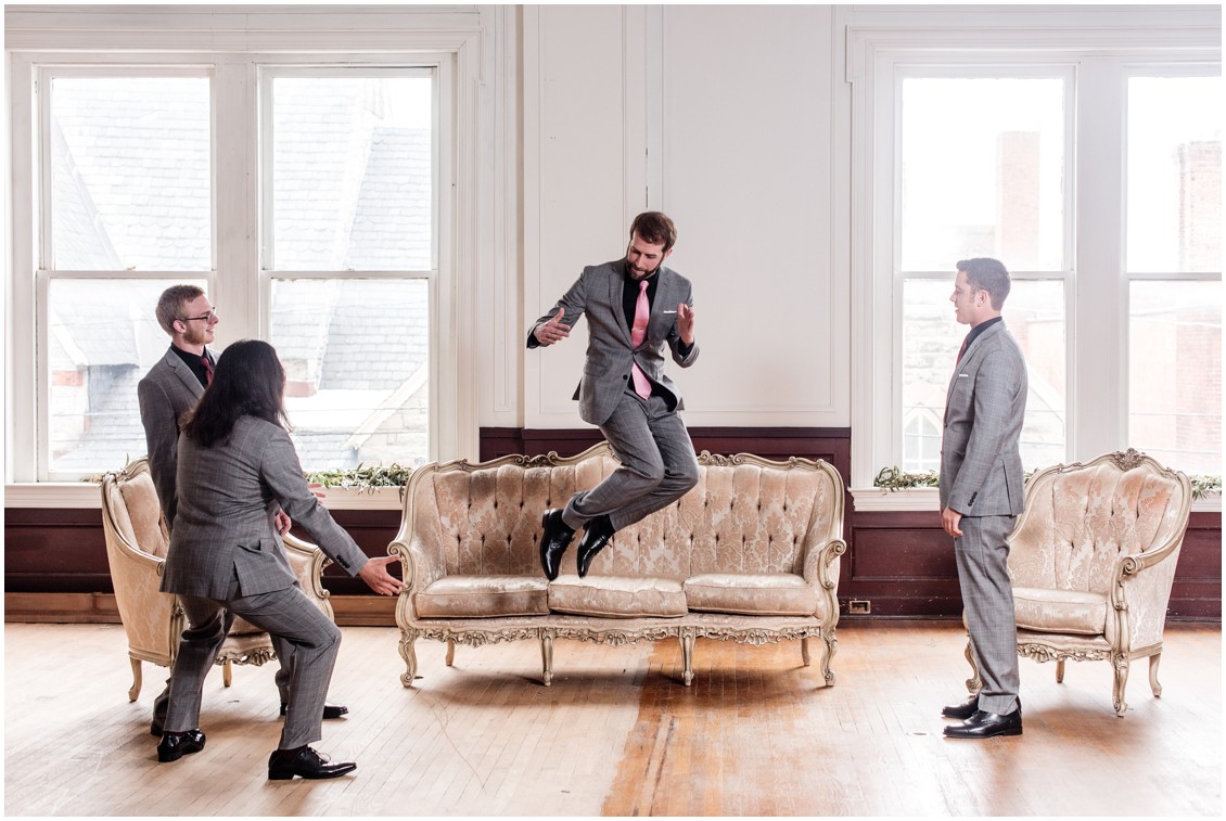 Groom having fun with his groomsmen, gray suits with pink ties. | My Eastern Shore Wedding |