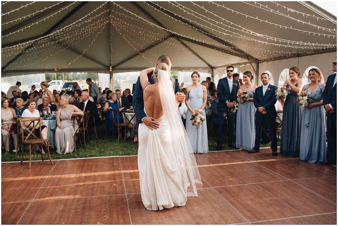 Bride and groom dancing under white tent and string lights at reception. | My Eastern Shore Wedding | 