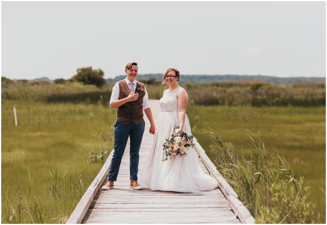 Married couple on long dock in the middle of tall grasses. | My Eastern Shore Wedding | 
