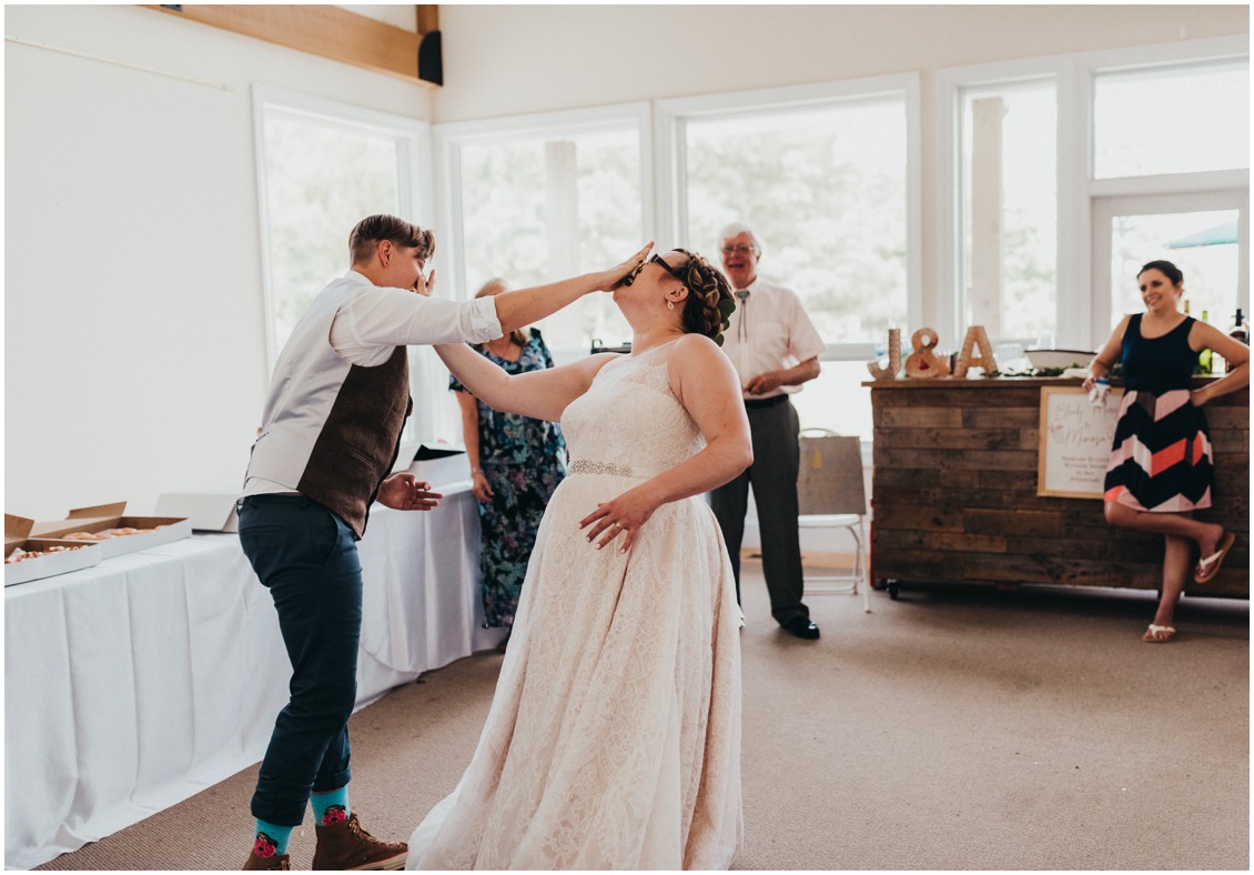 Couple smash donut slices into each other's face. | My Eastern Shore Wedding | 