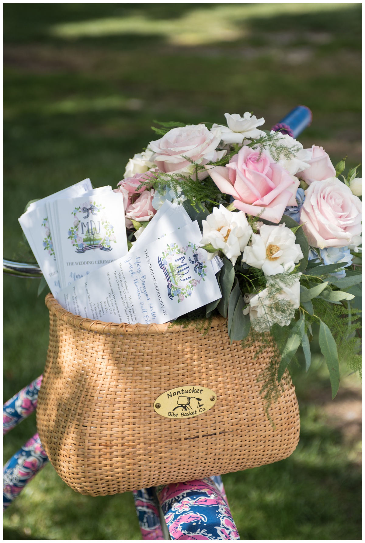 pink and blue beach cruiser bike with nantucket bike basket of flowers and wedding day schedule - guest itinerary at outdoor ceremony in june on maryland's eastern shore - now featured on My Eastern Shore Wedding - rustic beach nautical wedding inspo for couples on the eastern shore and chesapeake bay area