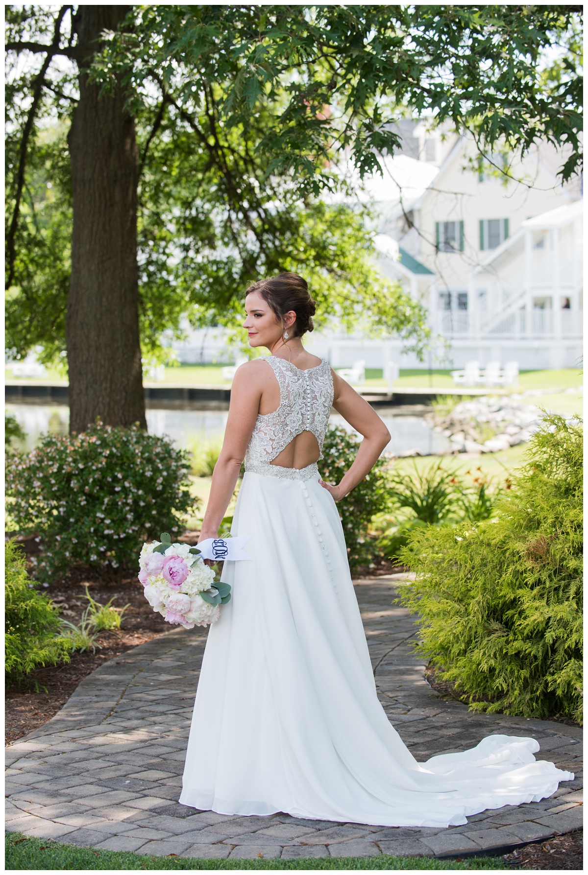 wedding dress details - bridal portrait outdoors at cove - waterfront wedding venue - the oaks waterfront inn wedding in the summer - light pink and white floral bouquet and back of sequin and lace wedding gown - floor length - with buttons and cut out back details
