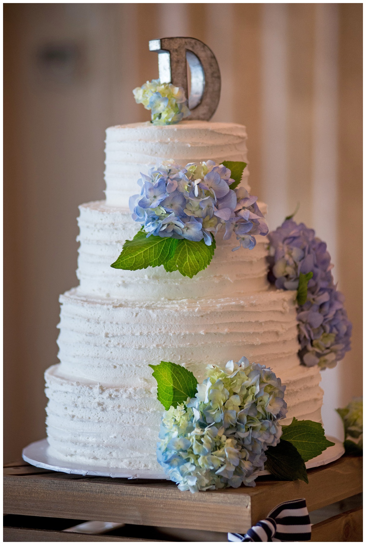 tiered wedding cake - white with blue hydrangea flowers and customized cake topper - rustic - chesapeake bay wedding on maryland eastern shore in the summer in june at the oaks waterfront inn - perfectly charming wedding inspiration | My Eastern Shore Wedding