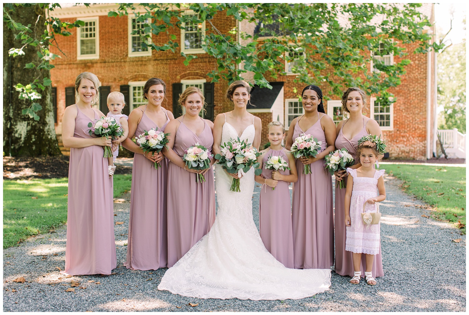 worsell manor wedding in the summer - warwick md - now featured on My Eastern Shore Wedding - coastal - sea - nautical - eastern shore - inspired wedding ideas and inspo - photo of bride bridesmaids and flower girl outdoors in front of brick manor style building