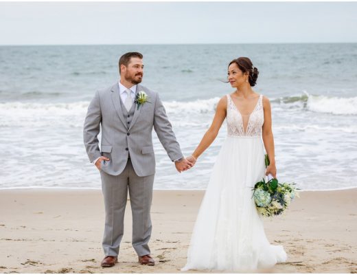 Bride and groom holding hands on the beach