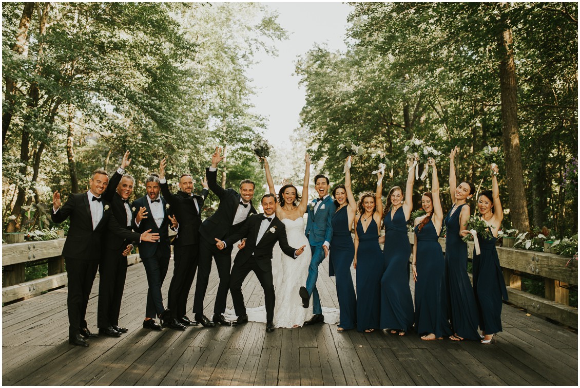 Entire bridal party holding hands in the air  | My Eastern Shore Wedding