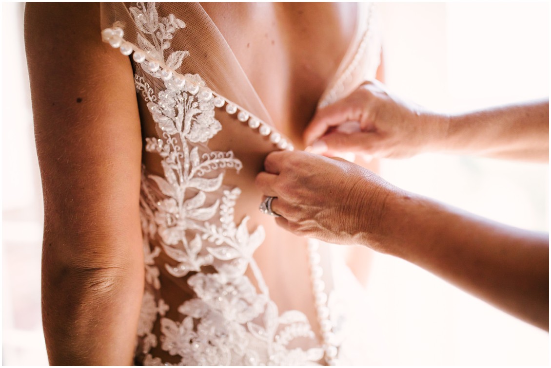 Detail of bridal gown with pearl buttons, bride getting ready | Kingsbay Mansion| My Eastern Shore Wedding