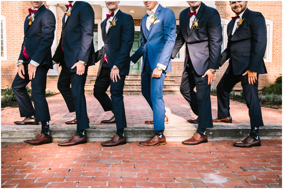Groom with groomsmen showing off shoes in front of mansion| Kingsbay Mansion| My Eastern Shore Wedding
