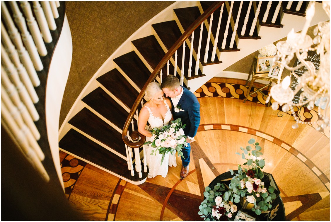 Bride and groom portraits on grand staircase in historic mansion | Kingsbay Mansion| My Eastern Shore Wedding