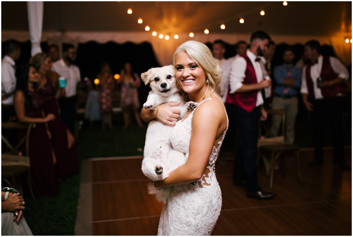 Bride with dog at reception on dance floor in tent | Kingsbay Mansion| Dover Tents and Events |My Eastern Shore Wedding