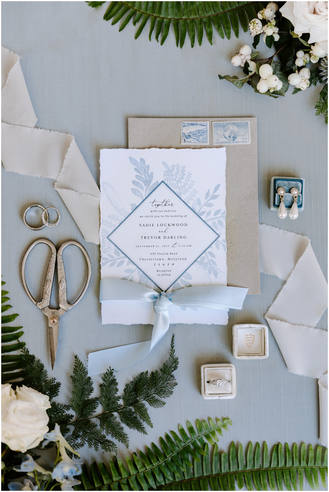 Demure blue and soft green flat lay of wedding stationery and details | My Eastern Shore Wedding | Sherwood Florist