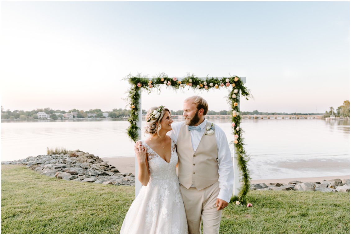 Bride and groom portrait in front of decorative arch | My Eastern Shore Wedding | Sherwood Florist
