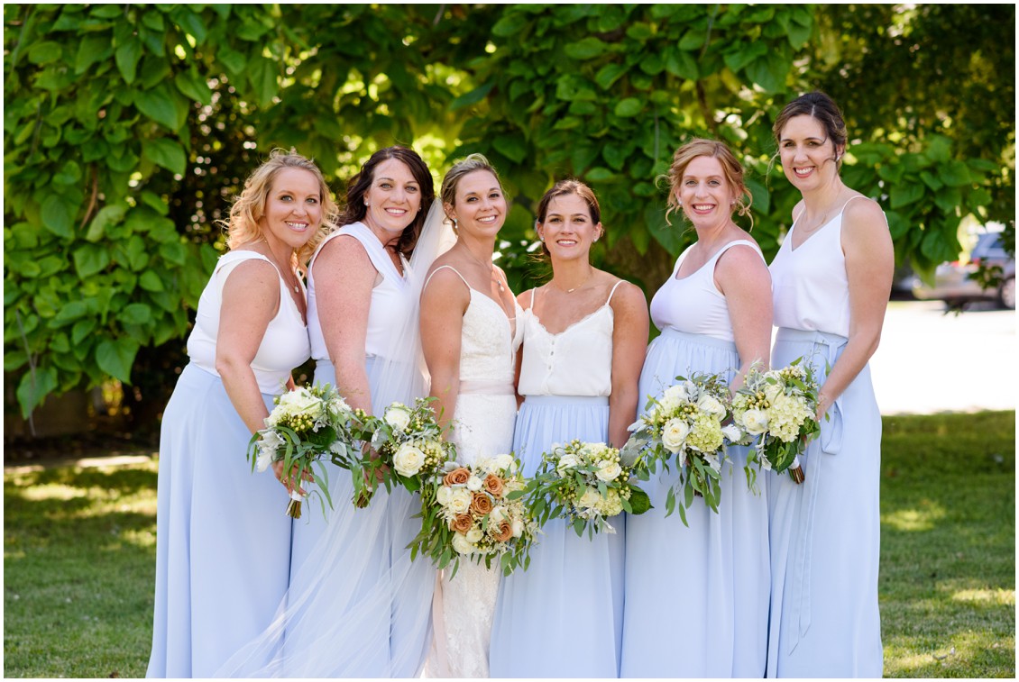 Bride with bridesmaids in blue skirts and white tops| My Eastern Shore Wedding | J. Nicole Photography