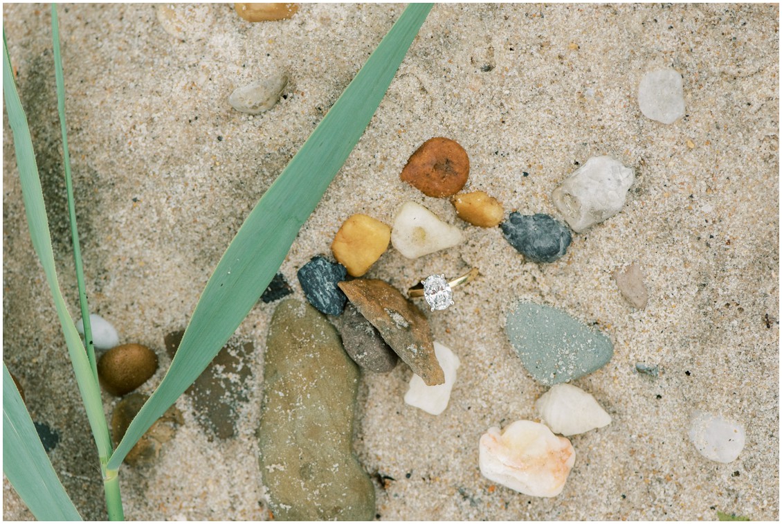 Detail of oval engagement ring in the sand with seaglass | My Eastern Shore Wedding | Romantic Oxford engagement shoot