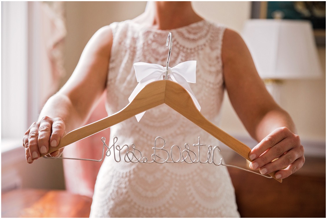 Bride holding up custom hanger | My Eastern Shore Wedding | Chelsea Fluharty Photography