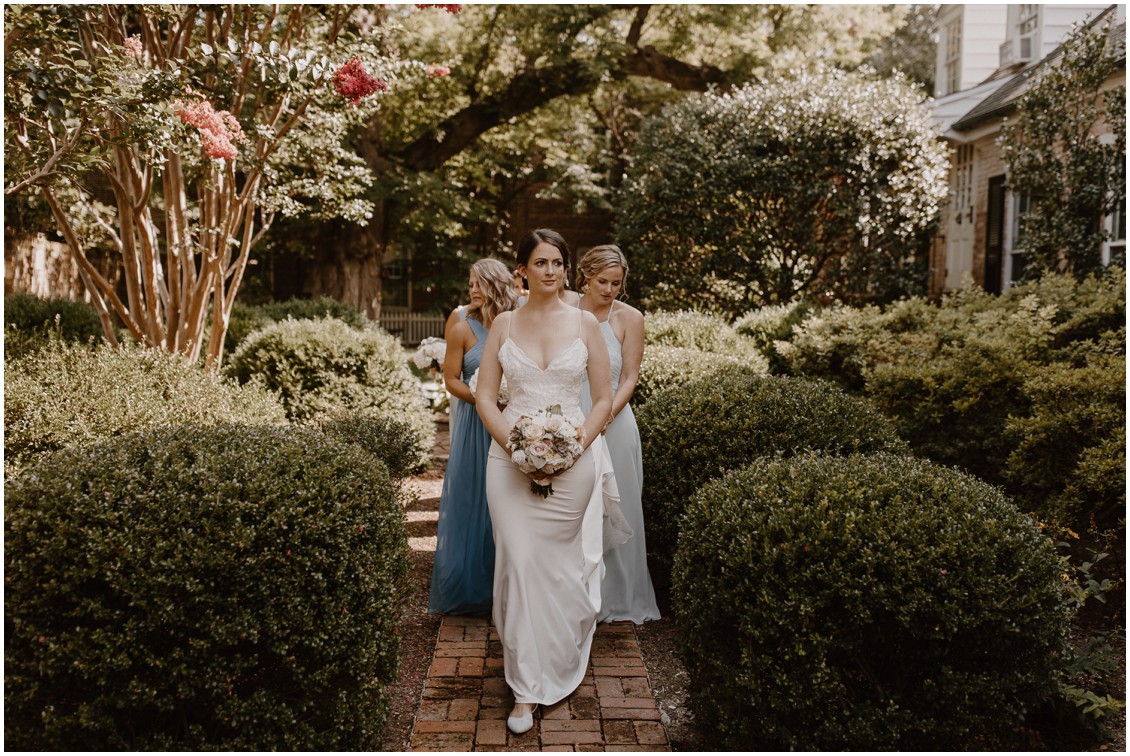 Bride in simple and stunning gown with bridesmaids in historic garden| My Eastern Shore Wedding |The Tidewater Inn