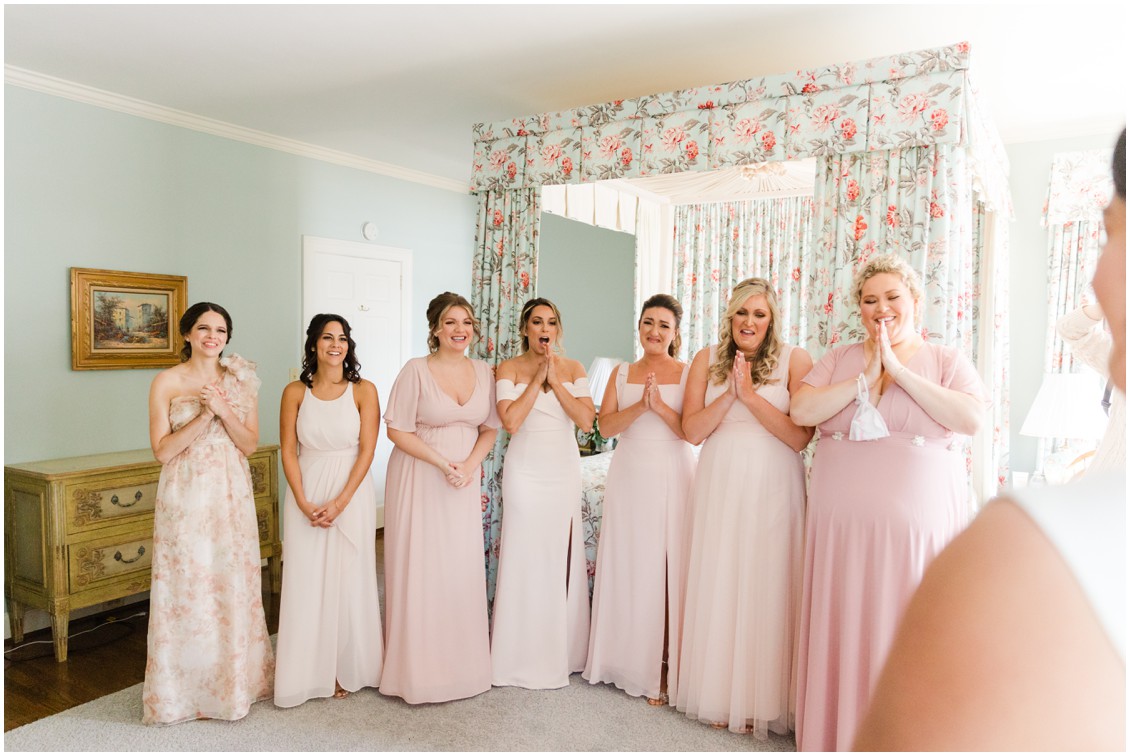 Mismatched bridesmaids dresses in shades of pink first look with bride glam winter wedding | My Eastern Shore Wedding | Sherwood Florist