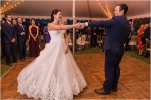 The couple celebrates their marriage with a first dance, showing off the beautiful lace wedding dress in a romantic twirl. | My Eastern Shore Wedding | Laura's Focus Photography