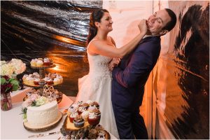 The bride playfully puts cake on the groom's face. | My Eastern Shore Wedding | Laura's Focus Photography