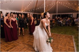 The bride throws her bouquet to an eagerly awaiting crowd of ladies. | My Eastern Shore Wedding | Laura's Focus Photography