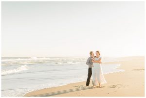 The couple dances on the beach before sunset and embraces in a hug. | My Eastern Shore Wedding | Cassidy MR. Photography