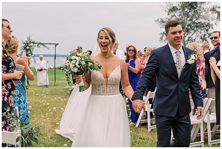 Beaming with joy down the aisle at the Hyatt Regency Chesapeake Bay | Laura's Focus Photography