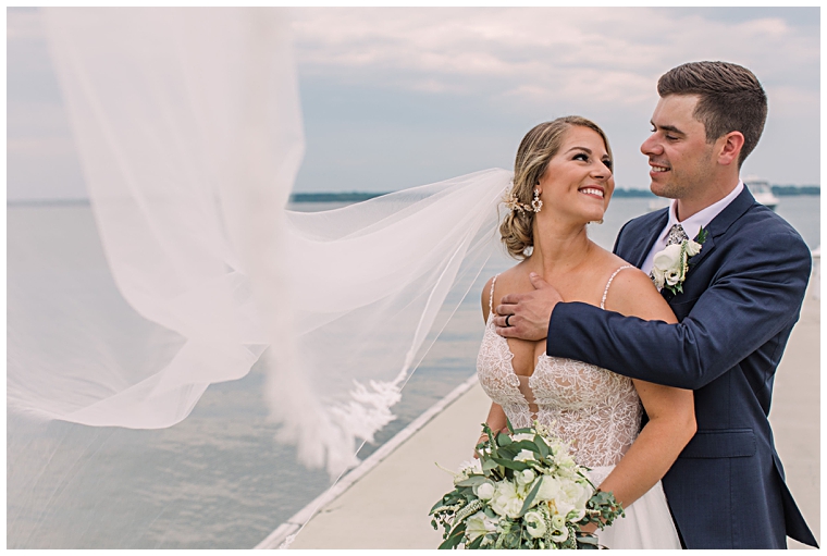 The bride and groom share a private moment on the dock at the Hyatt Regency Chesapeake Bay | Laura's Focus Photography