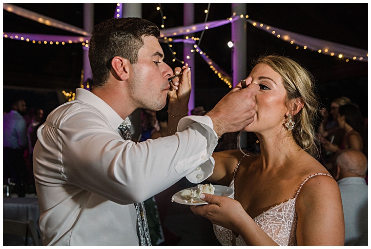 The bride and groom share the first piece of cake at the Hyatt Regency Chesapeake Bay | Laura's Focus Photography