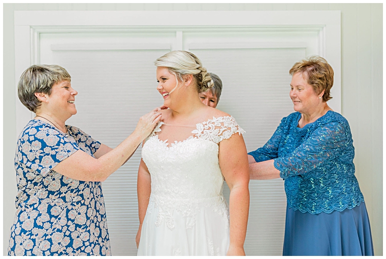 Bride's family helps her get dressed and ready for the ceremony | Cassidy MR Photography 