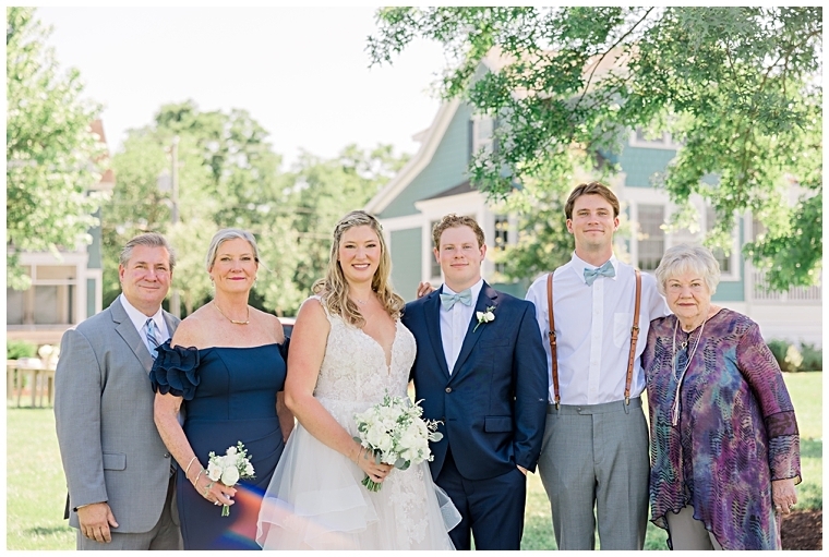 The bride's family poses for a picture with the new husband  | Inn at Haven Harbour 
