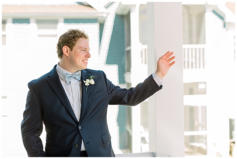 Portrait of groom waving to a friend walking by
