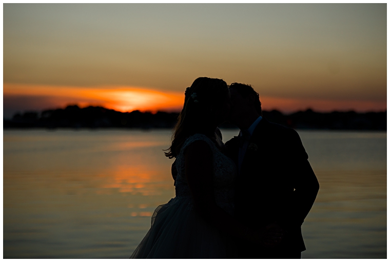 Bride and groom enjoy their waterfront sunset