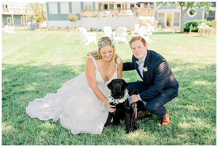 The bride and groom sit with their flower pup  | Inn at Haven Harbour 