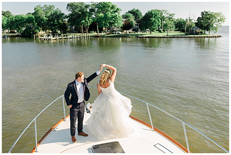 The bride and groom share a private first dance on the bow of the boat