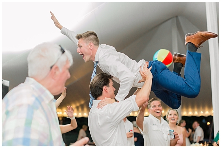 A dirty dancing moment on the dance floor as a groomsmen lifts a fellow guest into the air