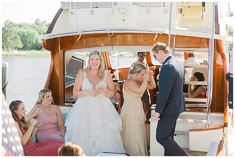 The bridal party departs the ceremony by boat to head to the reception