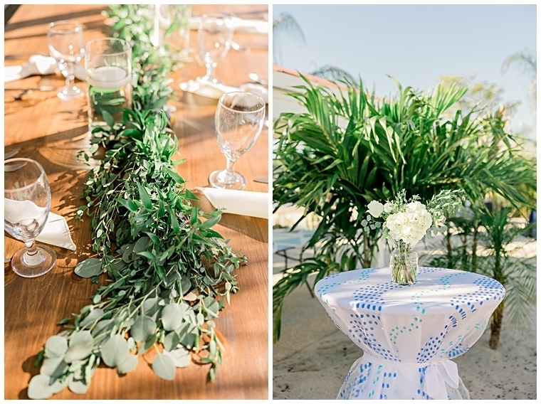 Reception details include a garland of greenery for the head table, and florals on the blue and white cocktail tables