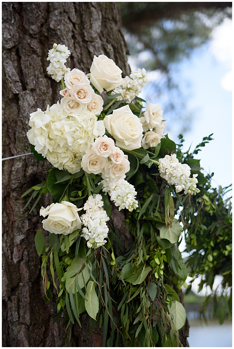 White roses and hydrangeas decorate the trees at the ceremony.