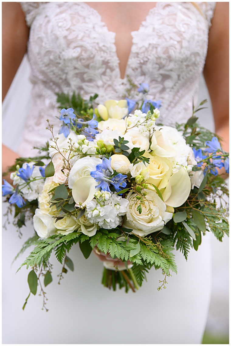A bridal bouquet by Seaberry Farms with white and green florals and hints of blue.
