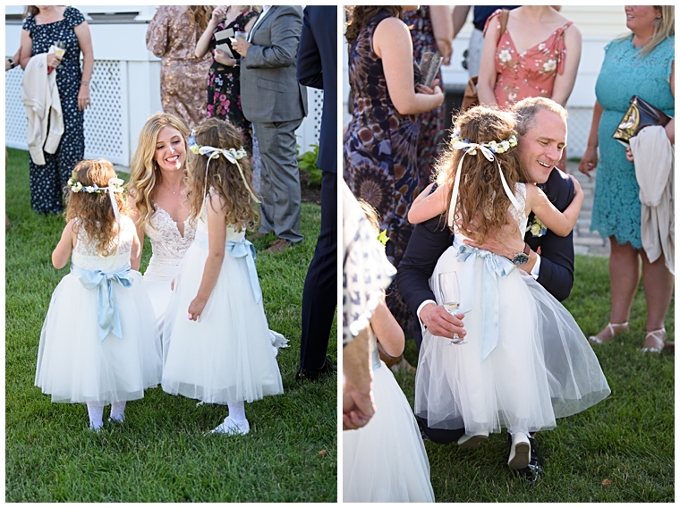 The bride and groom embrace their flower girls in celebration of their marriage