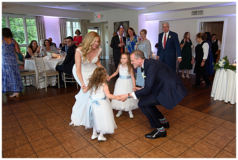 The bride and groom hit the dance floor with their flower girls