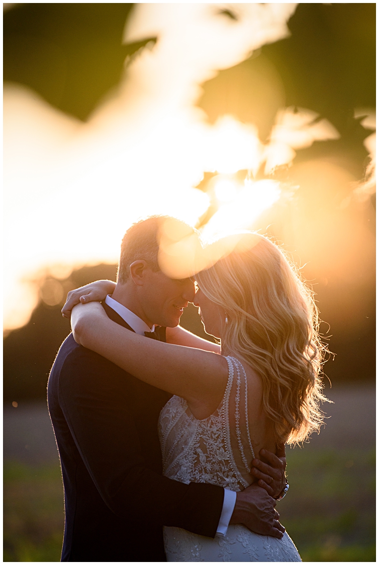 New husband and wife enjoy the sunset over the views at The Oaks Waterfront Inn | Kathy Blanchard Photography