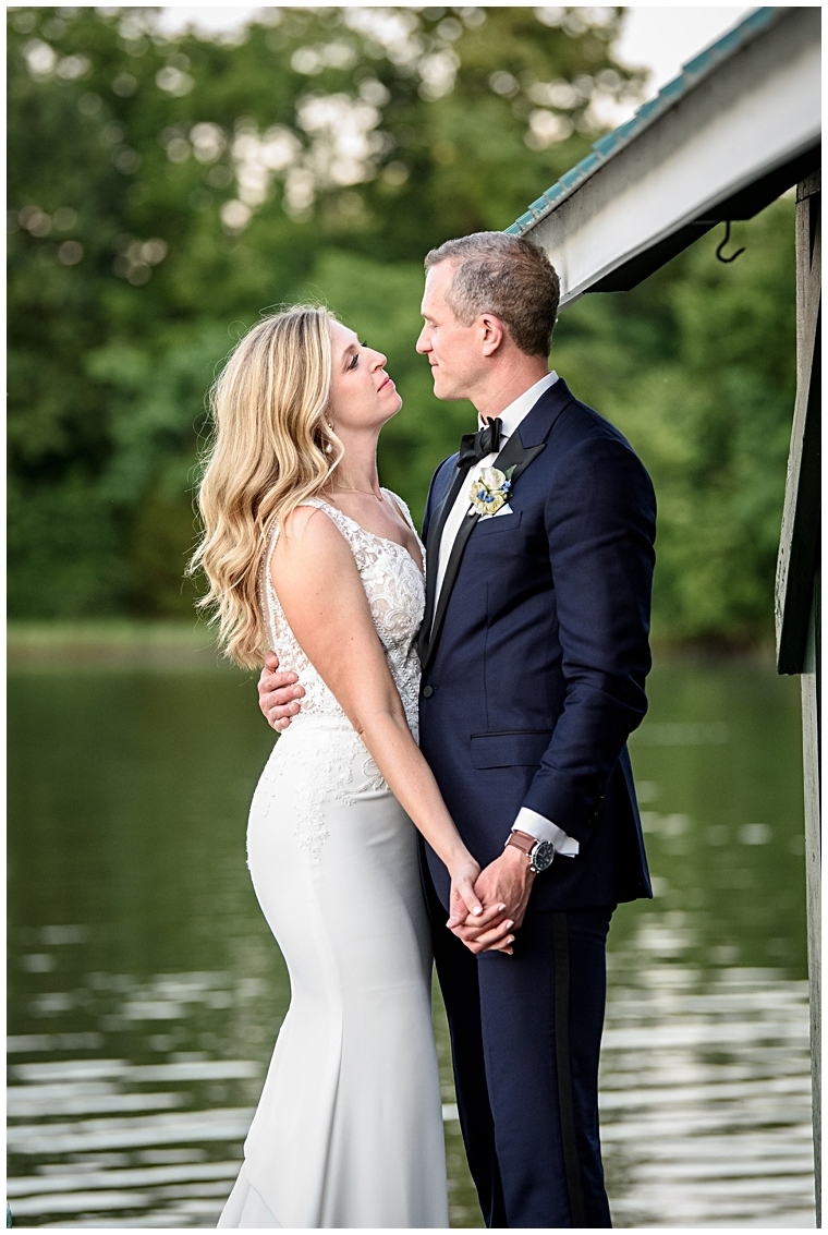 Bride and groom share a private moment at the waterfront at The Oaks