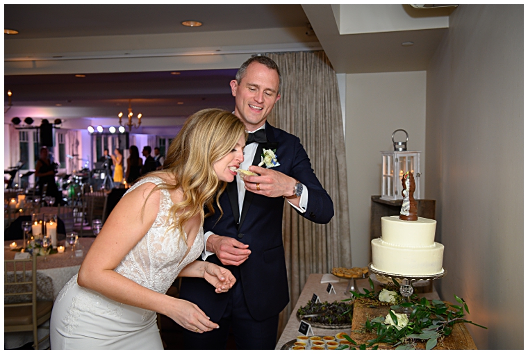 The newlyweds share a piece of cake from their dessert bar | The Oaks Waterfront Inn Catering