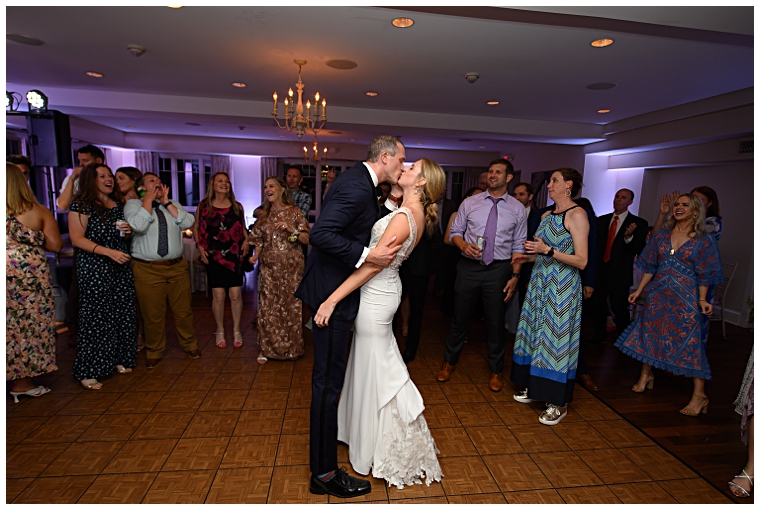 The bride and groom share a kiss on the dance floor to conclude their celebration