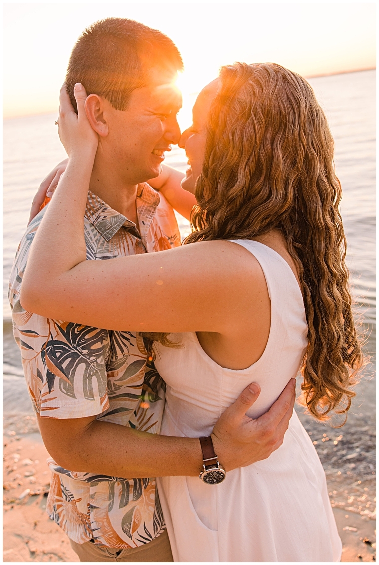 Embracing in a hug, the future newlyweds share a moment of romance on the beach. | Laura's Focus Photography | My Eastern Shore Wedding