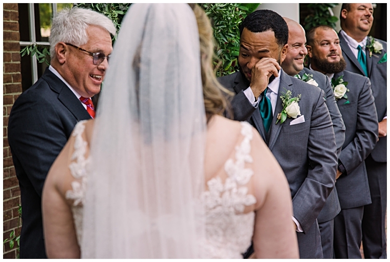 The groom tears up seeing his bride at the alter of their Tidewater Inn Wedding
