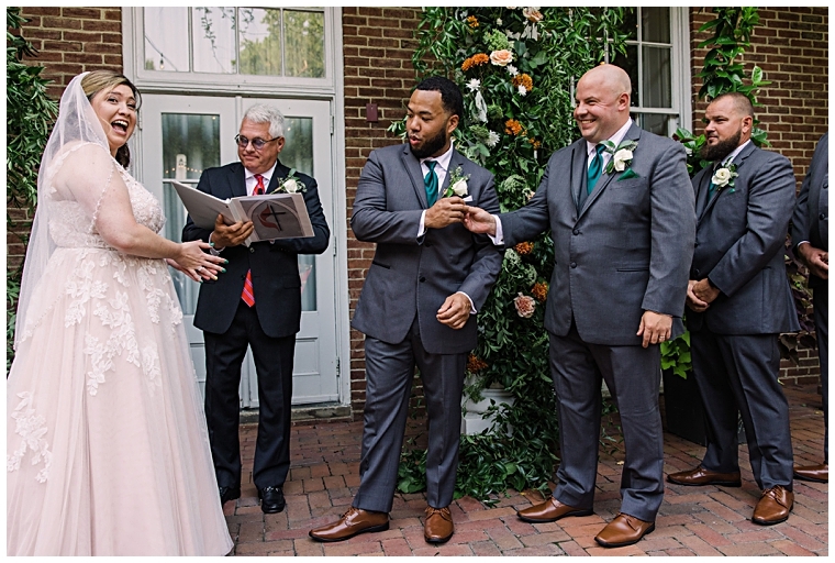 The best man congratulates the groom during the ceremony at The Tidewater Inn