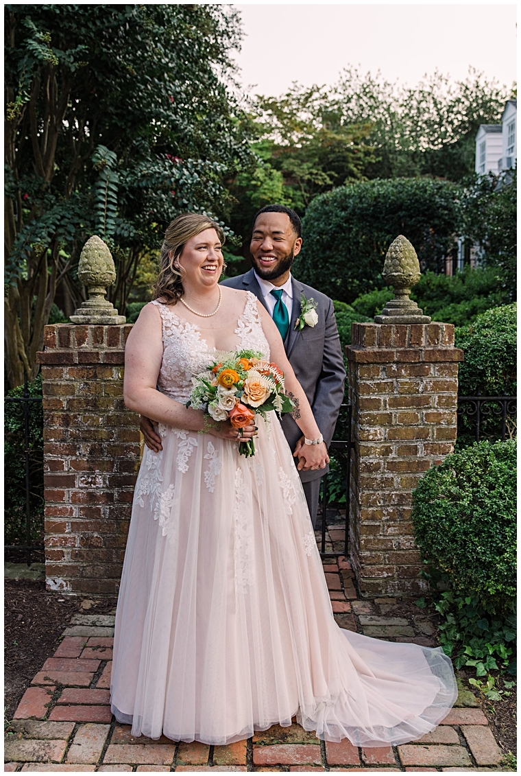 The happy couples poses for a portrait in the beautiful historic gardens of downtown Easton | My Eastern Shore Wedding
